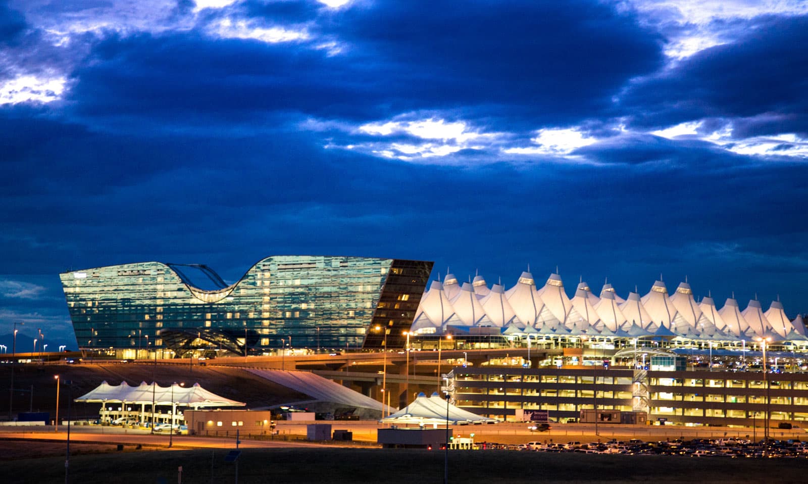 Denver International Airport tent roofs illuminated at night, wide telephoto shot